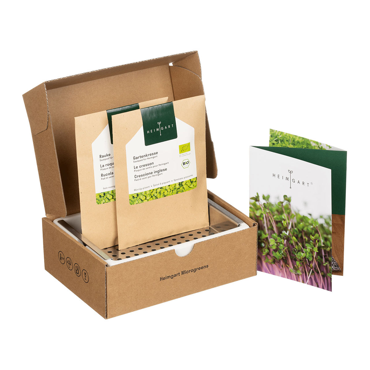 Heimgart Starter Set für Microgreens, geöffnete Box mit Saatpads „Rauke“ und „Gartenkresse“ sowie Anleitung